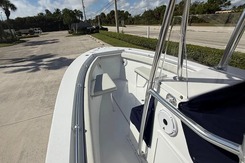 Slide: The Image of 2001 Contender 21 Open boat, white interior, docked outdoors on a sunny day. - 11