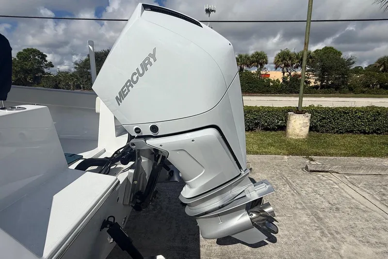 Slide: The Image of Mercury outboard motor on 2001 Contender 21 Open boat, parked outdoors. - 14