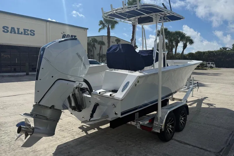 Slide: The Image of 2001 Contender 21 Open boat with Mercury outboard engine on trailer, parked outdoors. - 3