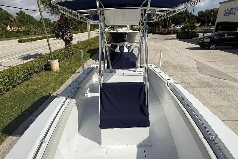 Slide: The Image of 2001 Contender 21 Open boat with blue covers, parked outdoors. - 5