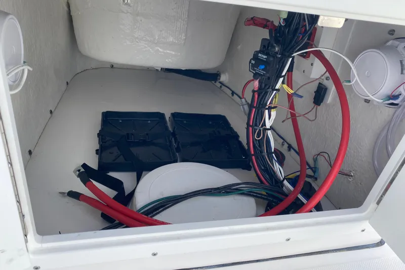 Slide: The Image of 2024 Tidewater 180 CC Adventure boat wiring and battery compartment. - 12