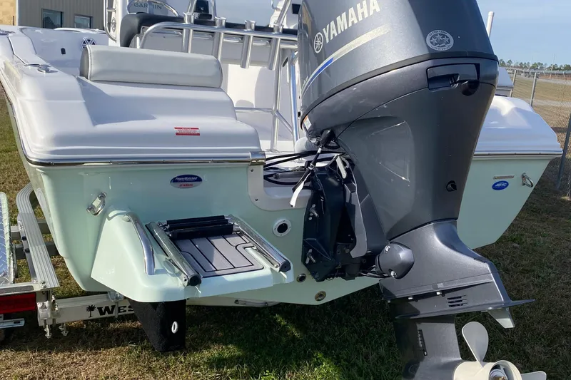 Slide: The Image of 2024 Tidewater 180 CC Adventure boat with Yamaha outboard motor, parked on trailer. - 2