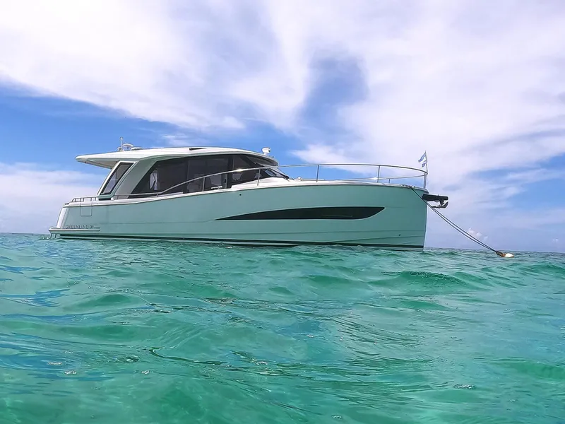 The Image of 2022 Greenline 39 Hybrid yacht anchored on clear turquoise water under a blue sky. - 0