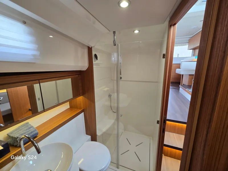 Slide: The Image of Luxurious bathroom interior of 2022 Greenline 39 Hybrid yacht, featuring modern fixtures and wooden accents. - 10
