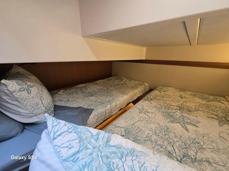 Slide: The Image of Cozy cabin beds in 2022 Greenline 39 Hybrid yacht, featuring ocean-themed bedding. - 13