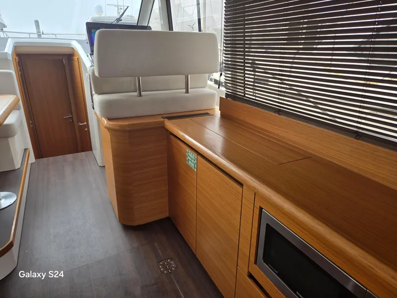 Slide: The Image of Interior of 2022 Greenline 39 Hybrid yacht with wooden cabinetry and modern design. - 15