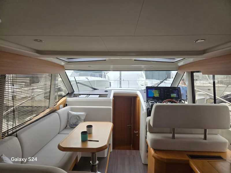 Slide: The Image of Interior of 2022 Greenline 39 Hybrid yacht, featuring modern seating and navigation equipment. - 16
