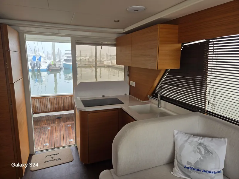 Slide: The Image of Interior of 2022 Greenline 39 Hybrid yacht with modern kitchen and marina view. - 18