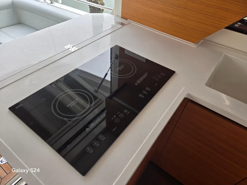 Slide: The Image of Modern kitchen on 2022 Greenline 39 Hybrid yacht with sleek induction cooktop. - 19