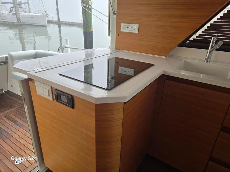 Slide: The Image of Modern kitchen on 2022 Greenline 39 Hybrid yacht with sleek countertops and appliances. - 20