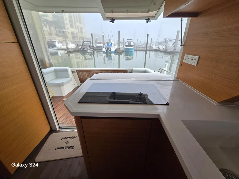 Slide: The Image of Interior view of 2022 Greenline 39 Hybrid yacht kitchen with marina backdrop. - 21