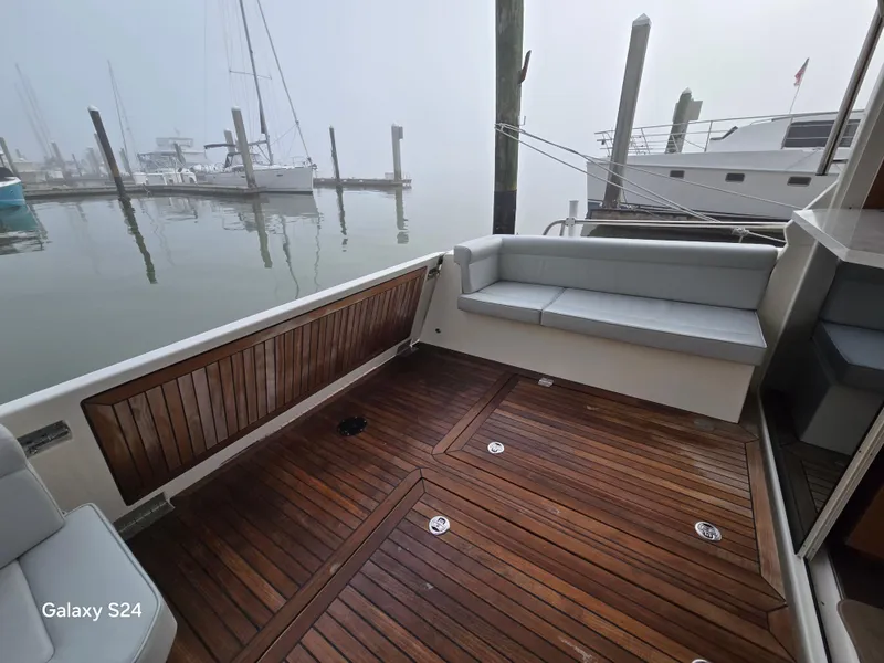 Slide: The Image of Deck of 2022 Greenline 39 Hybrid yacht with wooden flooring and cushioned seating. - 23