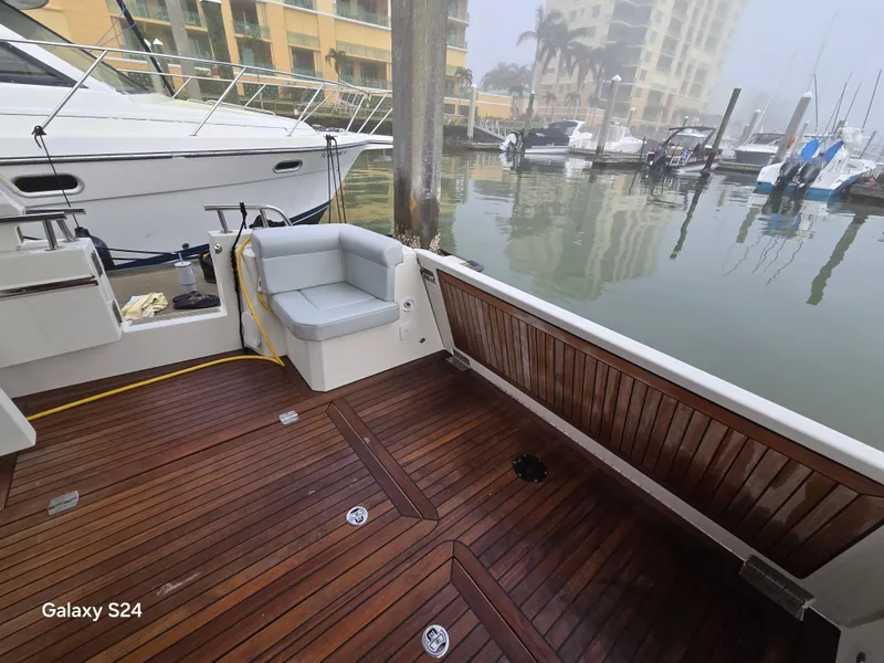 Slide: The Image of 2022 Greenline 39 Hybrid yacht with wooden deck, docked in a marina. - 24