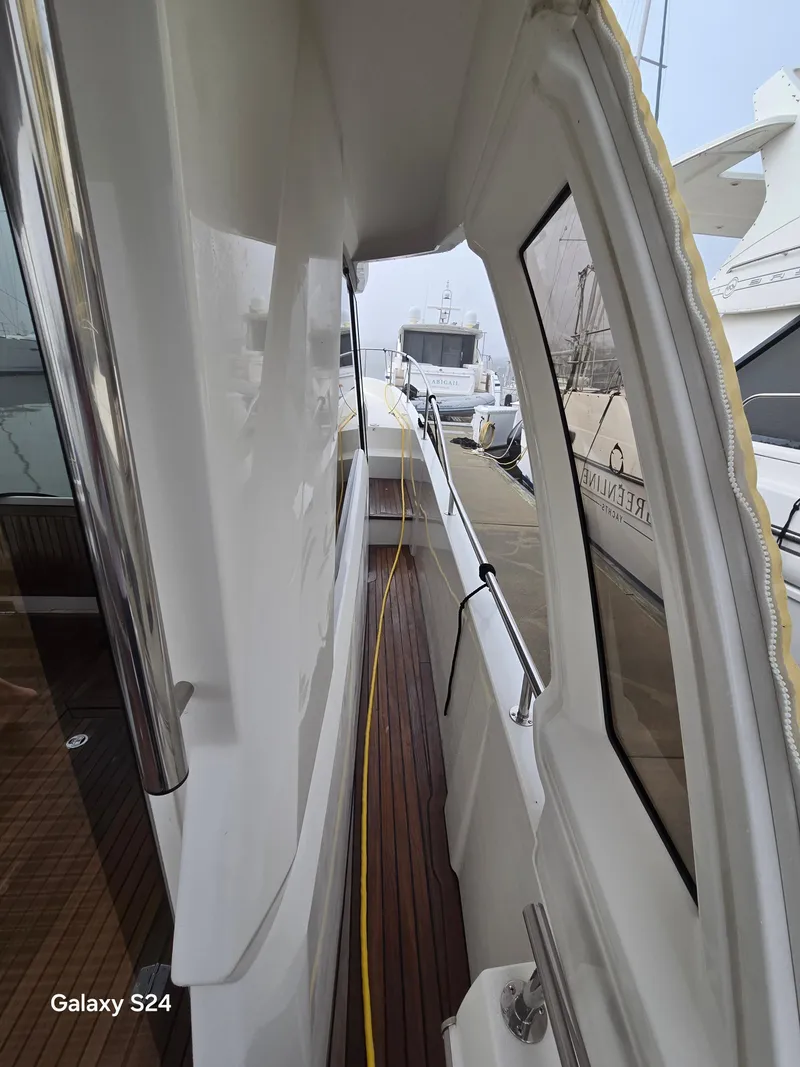 Slide: The Image of Side view of a 2022 Greenline 39 Hybrid yacht docked at a marina. - 25