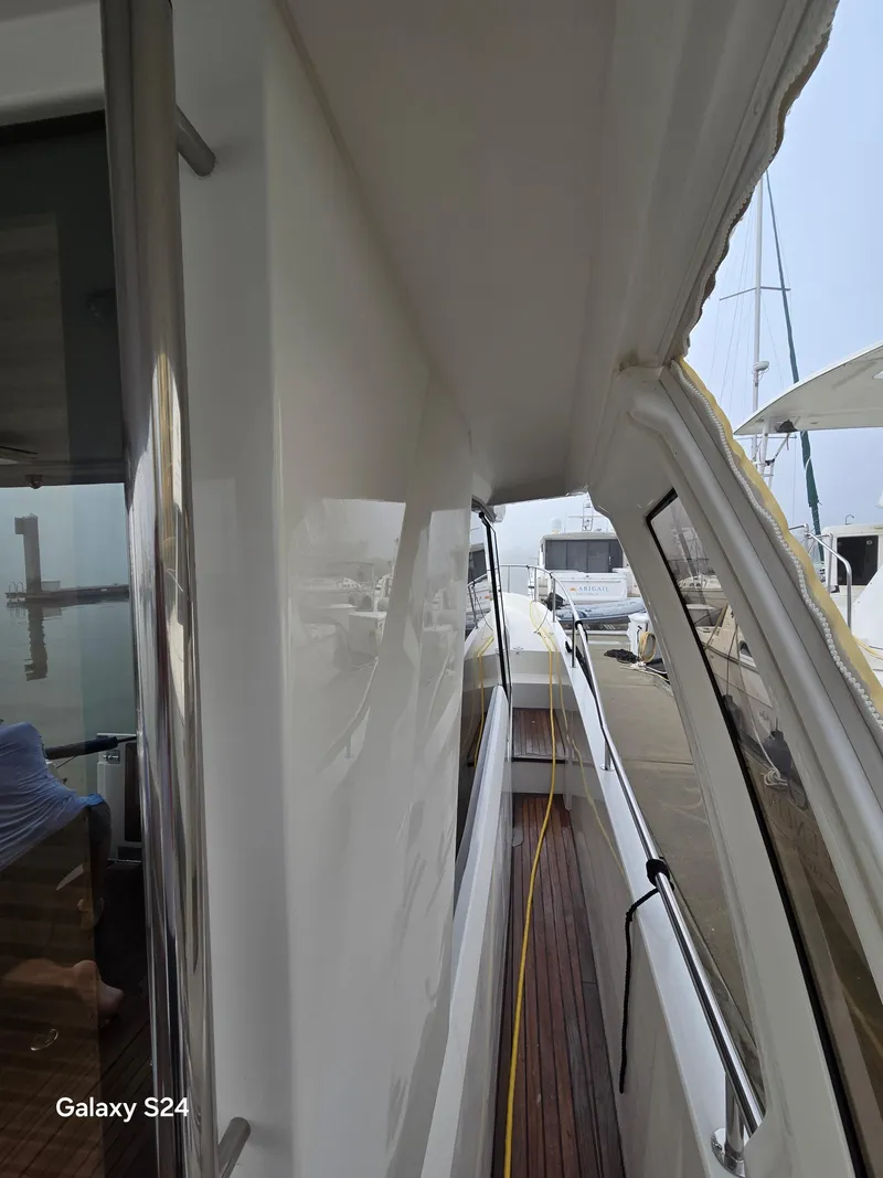 Slide: The Image of Side view of a 2022 Greenline 39 Hybrid yacht docked at a marina. - 26