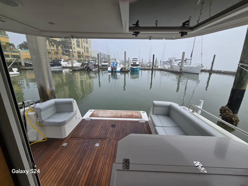 Slide: The Image of 2022 Greenline 39 Hybrid yacht interior with wooden deck and marina view. - 27
