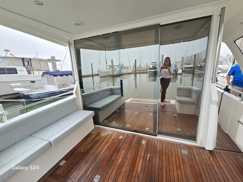 Slide: The Image of 2022 Greenline 39 Hybrid yacht interior with wooden deck and marina view. - 28