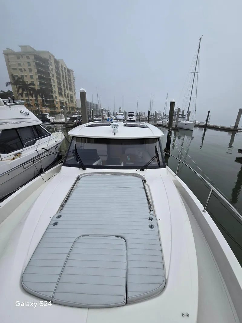 Slide: The Image of 2022 Greenline 39 Hybrid yacht docked in a foggy marina setting. - 29