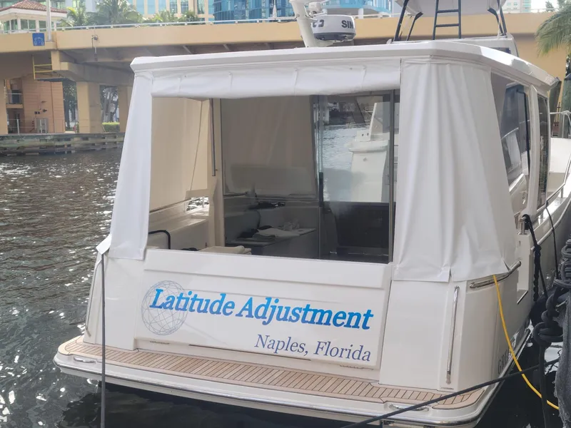 Slide: The Image of 2022 Greenline 39 Hybrid yacht named "Latitude Adjustment" docked in Naples, Florida. - 3