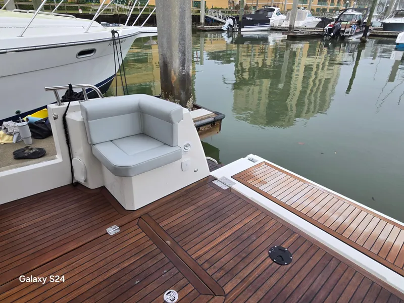 Slide: The Image of Luxury yacht deck with cushioned seating, docked in marina. Greenline 39 Hybrid, 2022 model. - 33