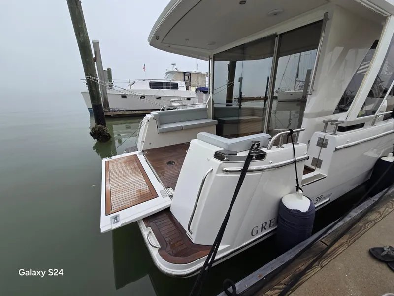 Slide: The Image of 2022 Greenline 39 Hybrid yacht docked, showcasing rear deck and sleek design. - 37