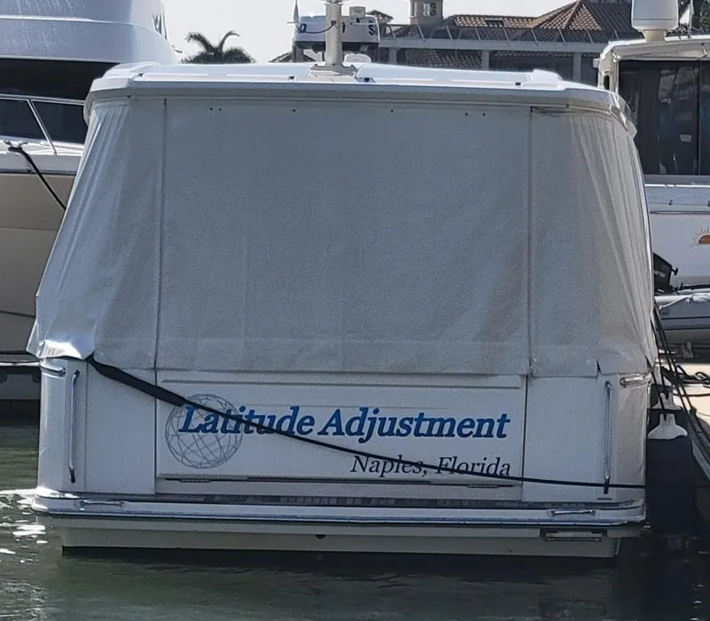 Slide: The Image of 2022 Greenline 39 Hybrid boat docked, covered, with "Latitude Adjustment" text, Naples, Florida. - 39
