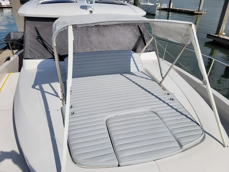 Slide: The Image of 2022 Greenline 39 Hybrid yacht with sunbed and canopy, docked at marina. - 41