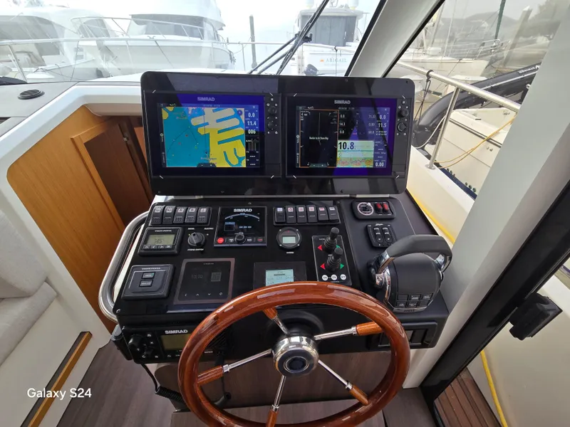 Slide: The Image of Helm of 2022 Greenline 39 Hybrid yacht with advanced navigation displays and controls. - 5