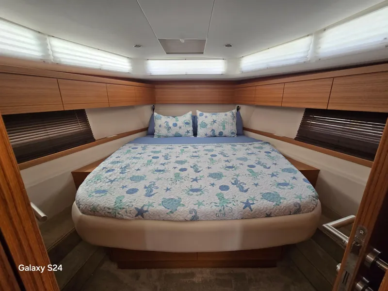 Slide: The Image of Luxurious bedroom interior of 2022 Greenline 39 Hybrid yacht with nautical-themed bedding. - 7