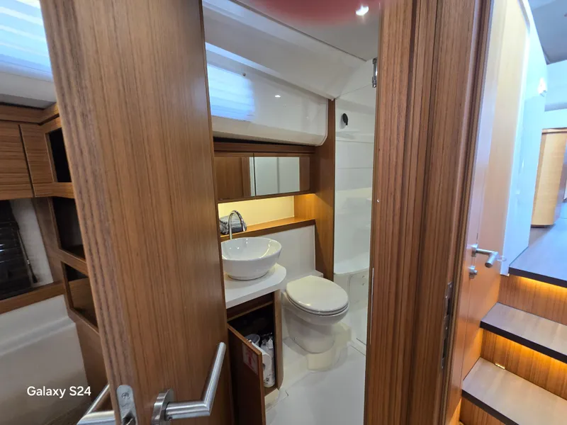 Slide: The Image of Luxurious bathroom interior of 2022 Greenline 39 Hybrid yacht, featuring modern wood finishes. - 8