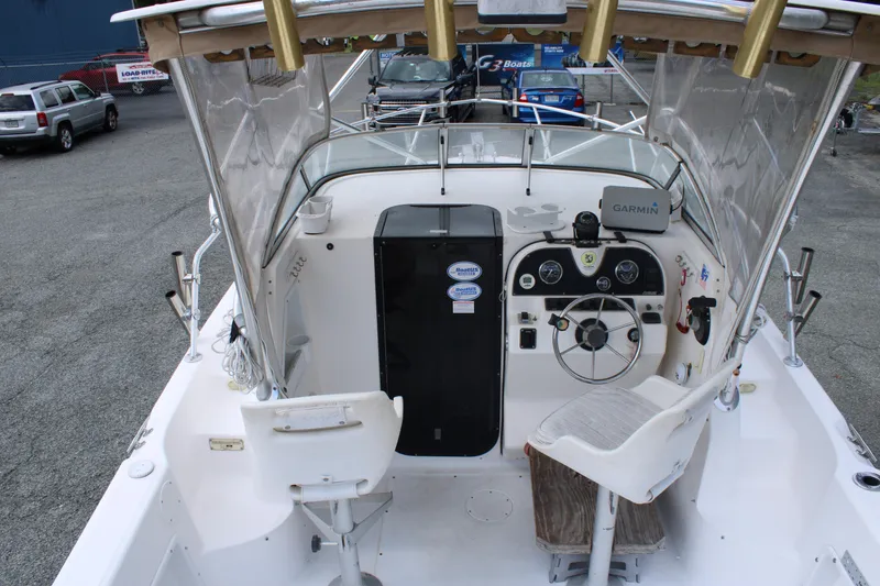 Slide: The Image of 2005 Angler 220 WA boat interior with steering wheel and Garmin navigation system. - 12