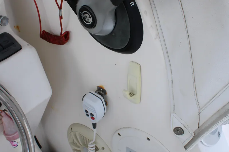 Slide: The Image of 2005 Angler 220 WA boat dashboard with steering wheel and control panel. - 16