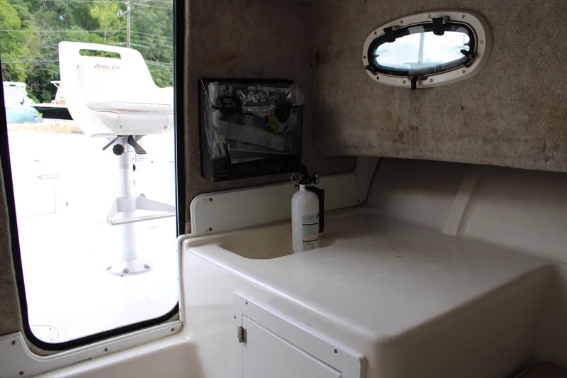 Slide: The Image of Interior of 2005 Angler 220 WA boat with fire extinguisher and seating. - 20