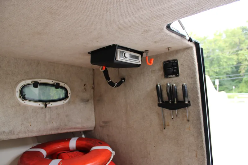 Slide: The Image of Interior of 2005 Angler 220 WA boat with tools and life preserver. - 22