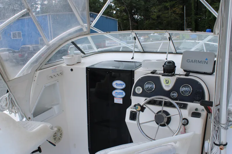 Slide: The Image of 2005 Angler 220 WA boat cockpit with Garmin navigation system and steering wheel. - 23