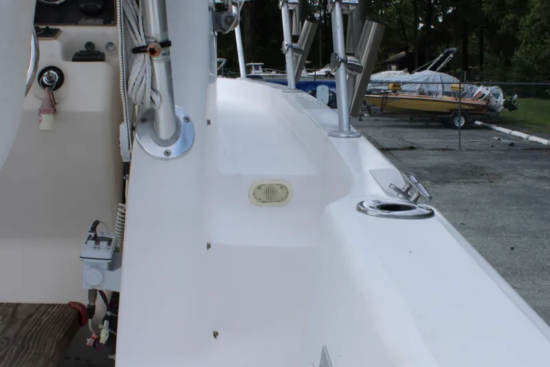 Slide: The Image of 2005 Angler 220 WA boat deck with rod holders and control panel. - 30