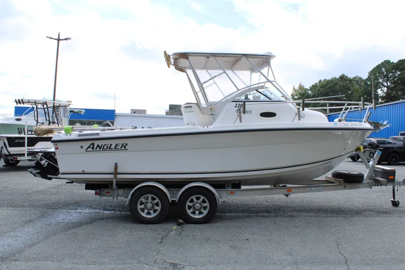 Slide: The Image of 2005 Angler 220 WA boat on trailer in parking lot. - 6