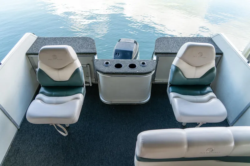 Slide: The Image of 2000 Sun Tracker Fishin' Barge 25 interior with two seats and motor view. - 13
