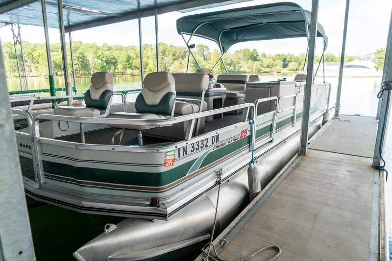 Slide: The Image of 2000 Sun Tracker Fishin' Barge 25 pontoon boat docked in a covered marina. - 4