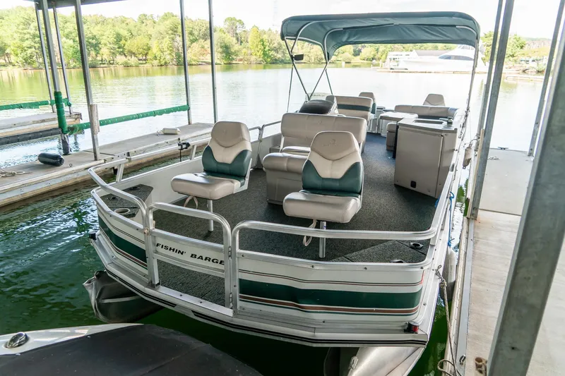 Slide: The Image of 2000 Sun Tracker Fishin' Barge 25 pontoon boat docked on a serene lake. - 7