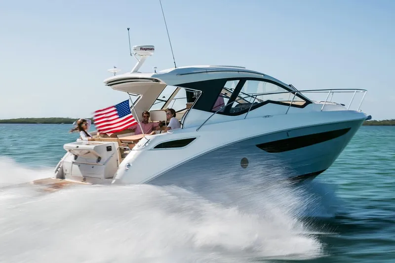 Slide: The Image of 2018 Sea Ray Sundancer 350 Coupe cruising on water with passengers. - 34
