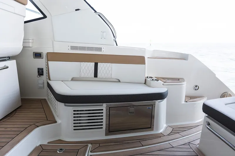 Slide: The Image of 2018 Sea Ray Sundancer 350 Coupe interior seating area with storage and wooden flooring. - 41