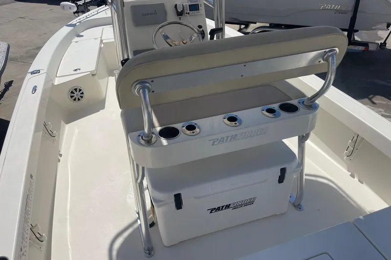 Slide: The Image of 2016 Pathfinder 2200 TRS boat interior with seating and console, featuring Garmin electronics. - 11