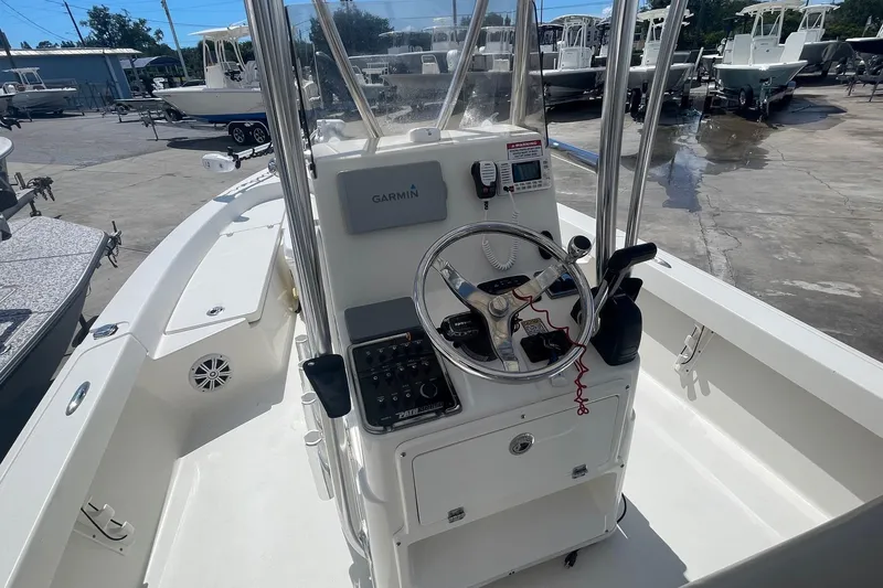 Slide: The Image of 2016 Pathfinder 2200 TRS boat console with Garmin navigation system in a marina setting. - 3