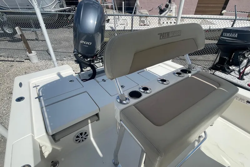 Slide: The Image of 2016 Pathfinder 2200 TRS boat interior with Yamaha 200 engine and seating area. - 4