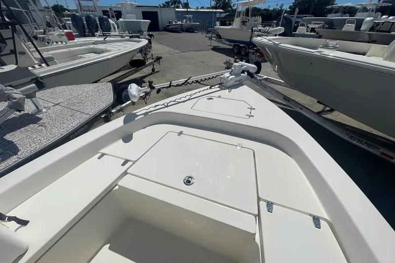 Slide: The Image of 2016 Pathfinder 2200 TRS boat on trailer in marina, surrounded by other boats. - 9