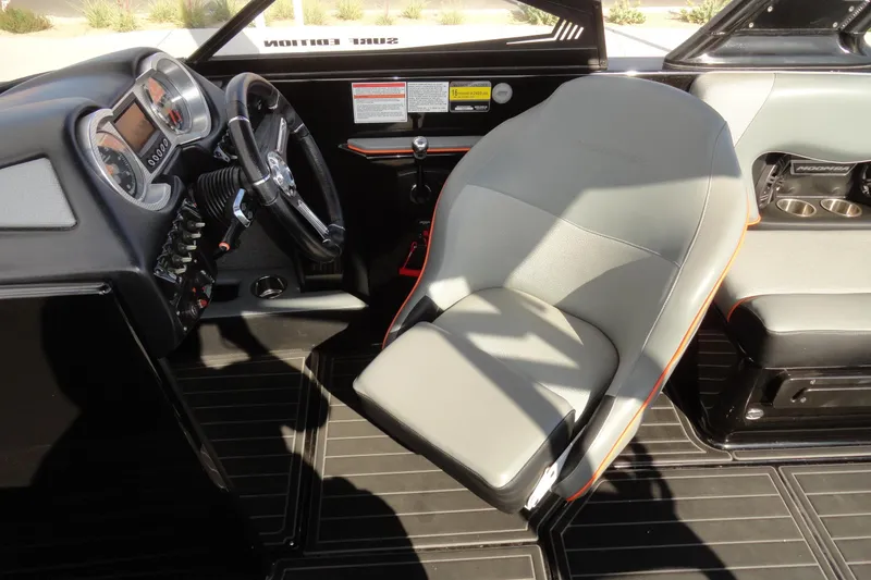 Slide: The Image of 2017 Moomba Craz boat interior with steering wheel and gray captain's seat. - 11