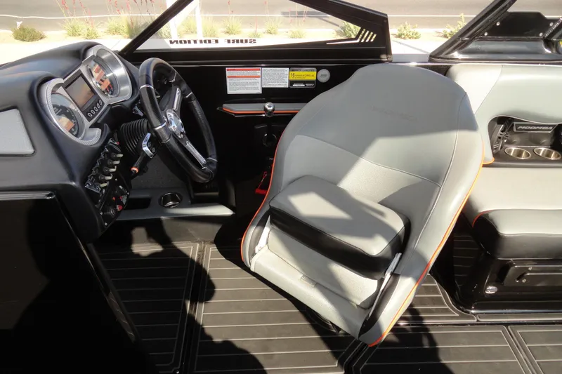 Slide: The Image of 2017 Moomba Craz boat interior with steering wheel and dashboard controls. - 12