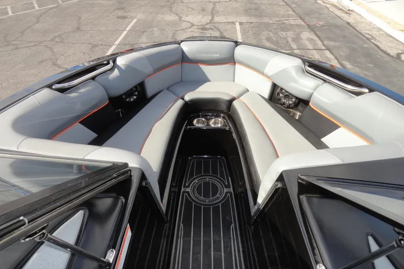 Slide: The Image of 2017 Moomba Craz boat interior with gray seating and orange accents. - 16