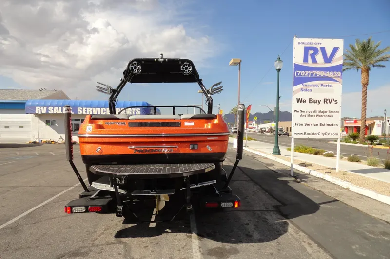 Slide: The Image of 2017 Moomba Craz boat parked near RV sales and service center under cloudy sky. - 22